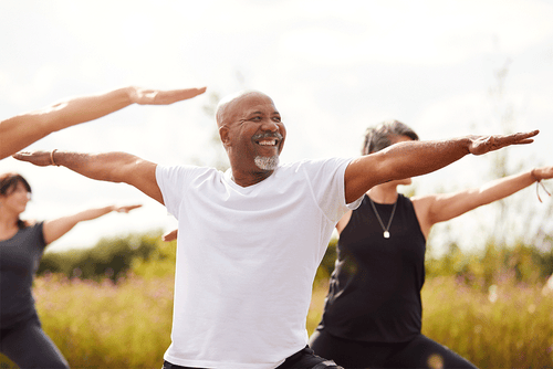 People practicing mindful outdoor yoga, illustrating somatic and body-based movement.